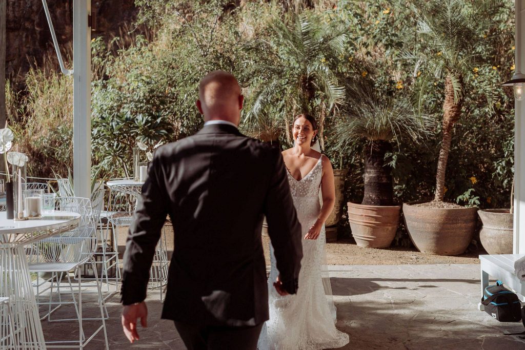 groom meets bride halfway down the aisle